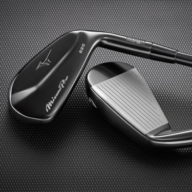 Mizuno Pro 225 Black ION lying on black background one club face up and one club back up