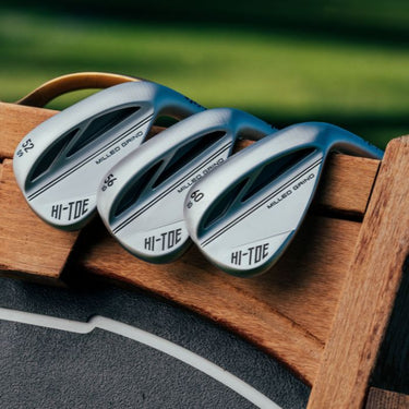 Three TaylorMade Hi-Toe 3 Wedges. Leant on top of wooden board. 