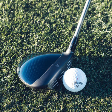 Callaway Golf Paradym Fairway Wood at the address of a Callaway Golf Ball on a fairway. Angle is showing the top of the club head and the face. 
