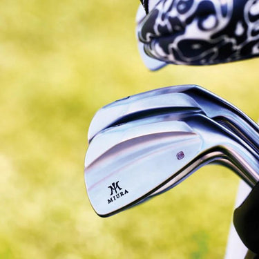 Miura KM-700 Golf Irons with grass background. 