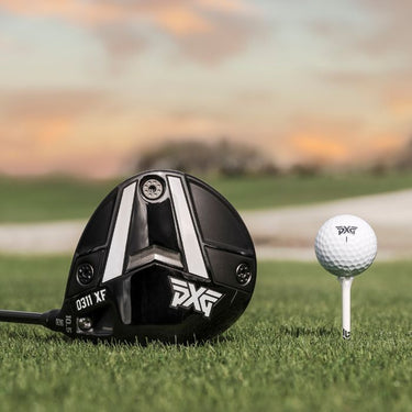 PXG 0311 XF GEN 6 Golf Driver lying on a fairway with PXG golf pall next to it