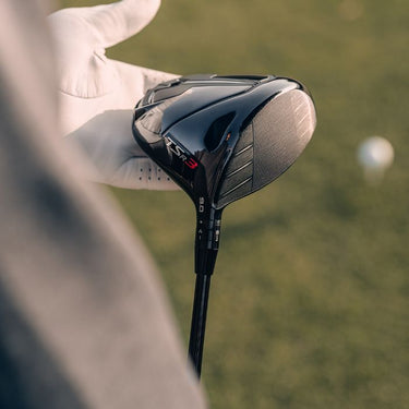 Titleist TSR3 Driver being head being held in the left hand of a golfer wearing a golf glove showing the sole and face
