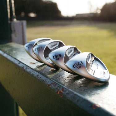 Cleveland CBX ZipCore Golf Wedges lying on metal with the sole of the club head showing